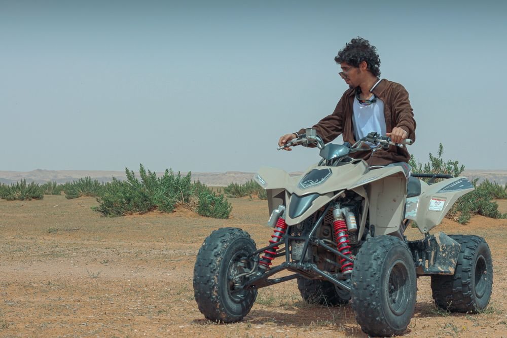 Quad biking across vast desert dunes